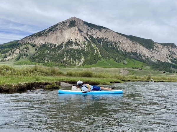 Instructor floating down a river