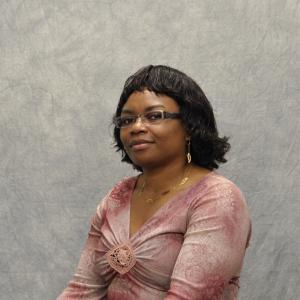 A photo of the faculty member against a gray background.