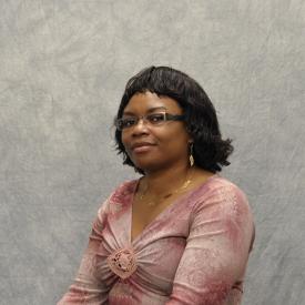 A photo of the faculty member against a gray background.